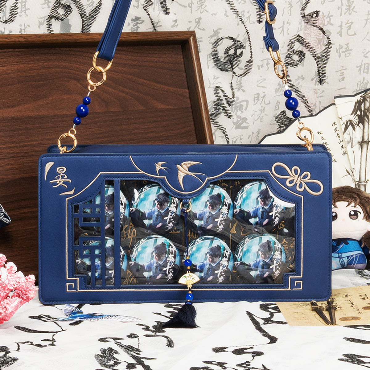 Blue Swallows Return Ita Bag displayed with anime pins and tassel details